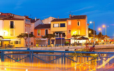 Fototapeta na wymiar Picturesque evening view of coastal town of Martigues divided by canals with colorful residential buildings along waterfronts in summer, France