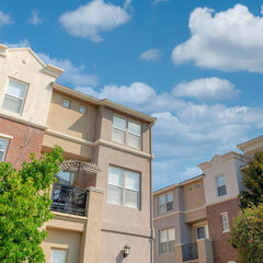Square White puffy clouds Modern classic low rise buildings at San Marcos, California