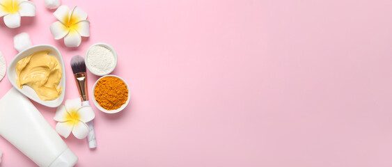 Turmeric face mask with ingredients and makeup brush on pink background with space for text