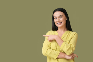 Beautiful woman with dental braces on color background