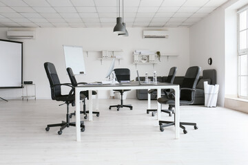 Interior of modern conference hall with big table and chairs