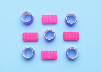 Different hair curlers on blue background