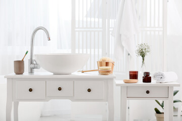 Fototapeta na wymiar Different bath supplies and modern sink in bathroom interior