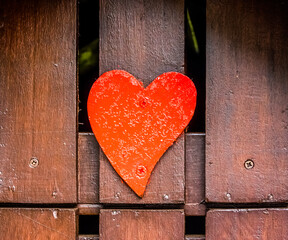 Red wooden heart on wood planks