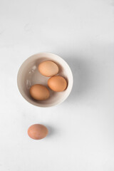 Eggs in a white bowl, brown eggs in a ceramic bowl, farm fresh eggs 