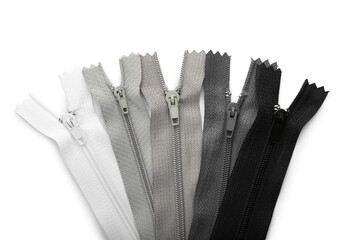Stylish different zippers on white background