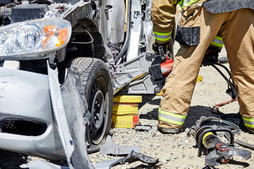 Fire Fighters using the Jaws of Life to dismantle a car