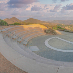 Square Puffy clouds at sunset Small half amphitheatre near the edge of a mountain slope in San