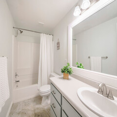 Fototapeta na wymiar Square Windowless white minimalist bathroom interior with marble tile flooring