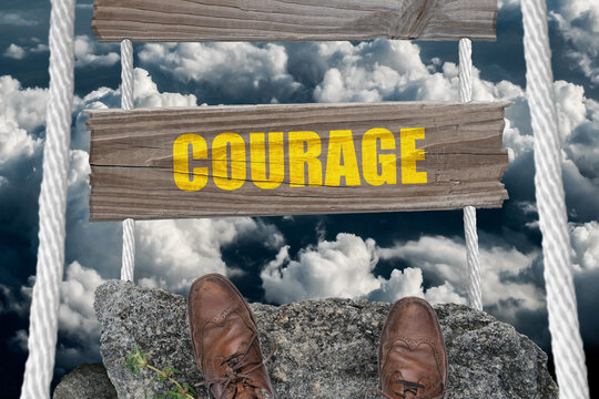 Courage text on dangerous bridge.