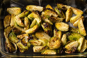 Brussels sprouts roasted in the oven with spices, salt, black pepper and Italian herbs in a glass...