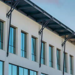 Square Puffy clouds at sunset Modern building with metal pillars on the roof at Daybreak in So