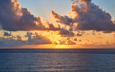 sunrise on the beach of punta sur isla mujeres. golden hour with stunning clouds. deep blue and orange tones.