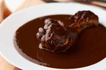 Chicken with mole, Mexican tradition, placed on wood