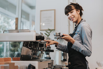Woman Barista using coffee machine in coffee shop. female barista working in coffee cafe. - obrazy, fototapety, plakaty