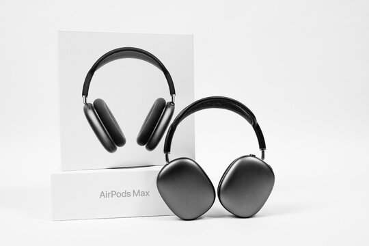 Rostov, Russia - April 04, 2022: Apple over-ear headphone AirPods Max of space gray color with modern cushion and soft flexible canopy on white background with open box, front view, copy space