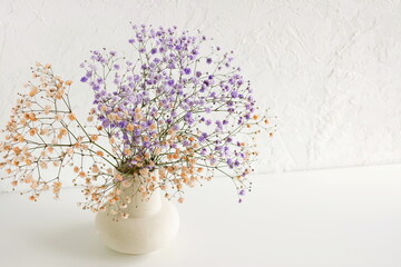 Flowers in a vase .Violet and beige gypsophila flowers or baby's breath flowers close up bouquet on...