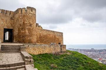 Derbent fortress Naryn Kala is the main touristic attraction in the city. Dagestan, North Caucasus, Russia. the city of Derbent in the distance, the blue sea and the sky.
