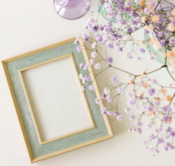 Frame mockup top view, vase with  flowers on white background.Neutral color. Photo frame, poster template. Scandinavian interior flat lay. Copy space.