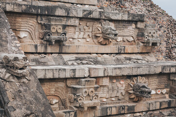 Details at the Temple of Quetzalcoatl (the Feathered Serpent) at Teotihuacan ancient city and vast archeological site in Central Mexico. The pyramid is decorated with stone carvings of the deity. 