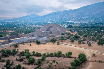 Perspective looking at the Pyramid of the Moon, at Teotihuacan, an ancient pre-Aztec City and archeological site in Central Mexico. View from above on top of the Pyramid of the Sun.