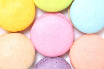 close up group of colorful macaroon pile on white background