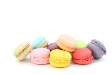 Close up many colorful fresh macarons pile isolated on white background, look delicious, have copyspace