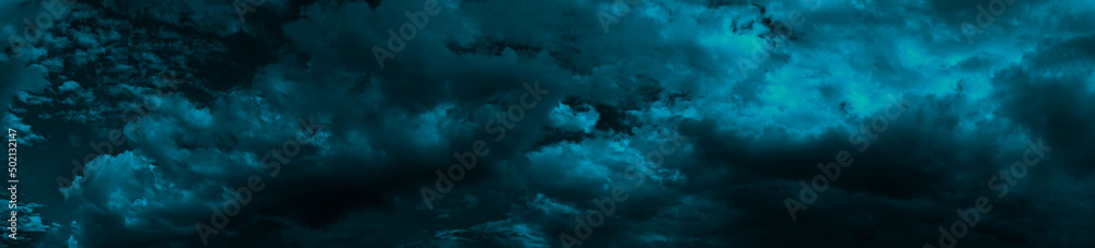 Wall mural heavy gloomy dull thunderclouds. dark teal dramatic night sky. storm. toned cloudy sky background wi