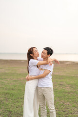 Fototapeta na wymiar Happy young Asian couple in bride and groom t-shirt