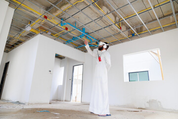 VR Glasses. Arab Business Man and civil engineer Wearing 3d VR Glasses Virtual metaverse future interior standing at the construction site