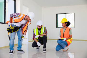 In doors. Professional Mechanical Engineer team wearing safety hard hat helmet working in  manufacturing factory under construction site.