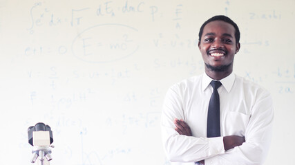 Smile African teacher is explaining science lessons inside the classroom with a  scientific...