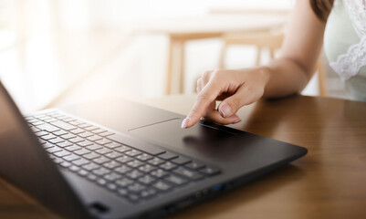 Female hand use laptop to working online or shopping and paying bill by using the application via the internet system, Close up view