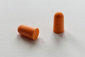 Orange foam ear plugs isolated on white background