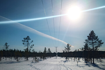 Light effects and vapor trail with power line in Swedish winter
