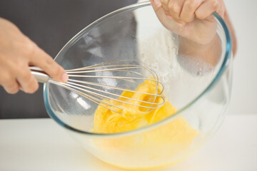 close up of hand whisking eggs