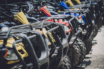 View of row dirty ATVs quad bike