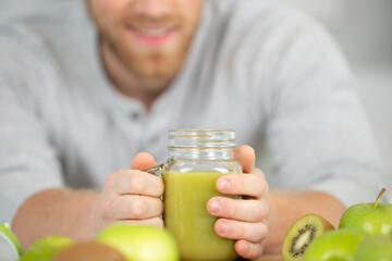 health man drinking weight loss green smoothie drink