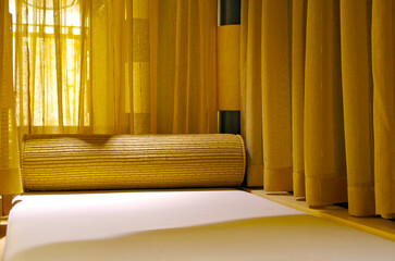 Relaxation room heated loungers with Balinese Asian decor inside spa wellness area thermal suite...