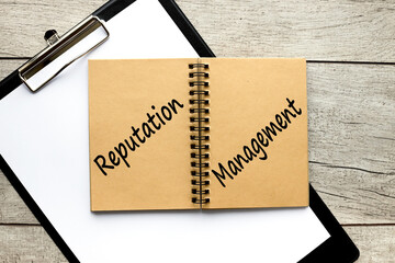 reputation management, text in a brown notepad.on a folder with a clip business concept