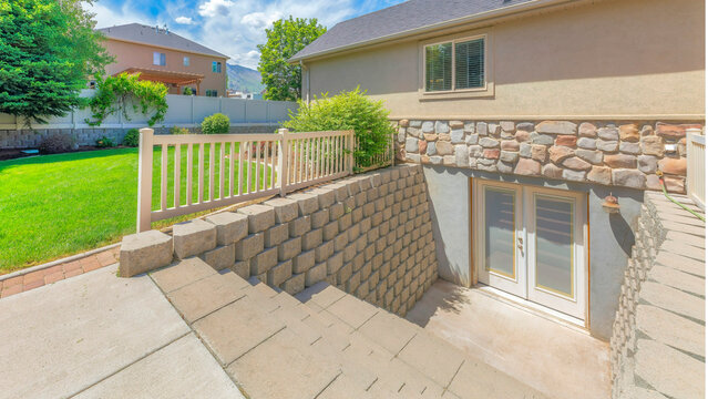 Panorama Whispy white clouds Basement entrance with glass panels on the double doors