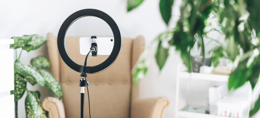 Mobile phone and ring lamp at home or office. Equipment for blogging and recording video broadcasts...