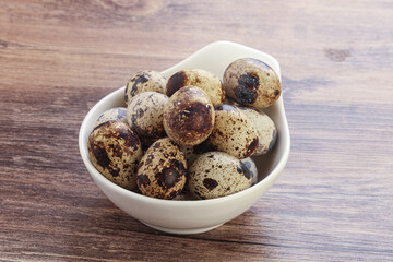Raw quail eggs heap in the bowl