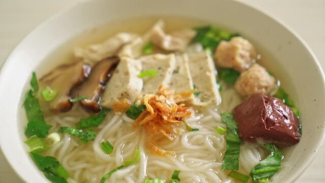 Vietnamese Rice Noodles Soup with Vietnamese Sausage served vegetables and crispy onion - Asian food style