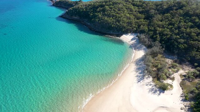 Stunning turquoise tropical water, empty white sand beach and bushland aerial over Great Keppel Island, Yeppoon, Queensland