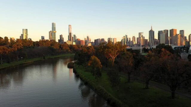 Melbourne cityscape sunrise aerial camera rising higher, revealing Yarra River reflection, Southbank, CBD skyline