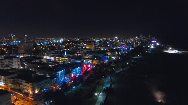 Miami Beach at night from drone. Ocean Drive and city skyline in slow motion