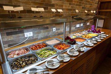 Breakfast served on a buffet table in a hotel restaurant