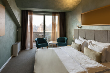 Interior of a luxury hotel double bed bedroom in the morning