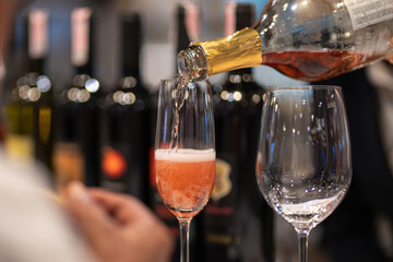 Background of pouring wine or champagne into the glass. drinking alcohol and celebrating party concept